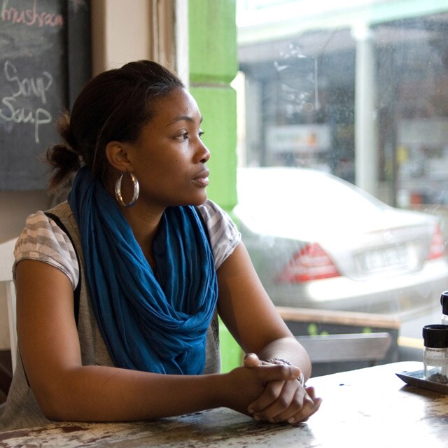 Woman sitting in a cafe staring out the window